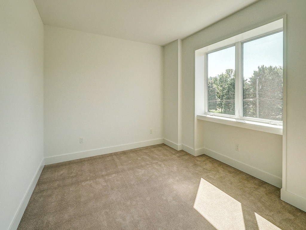 an empty living room with a large window