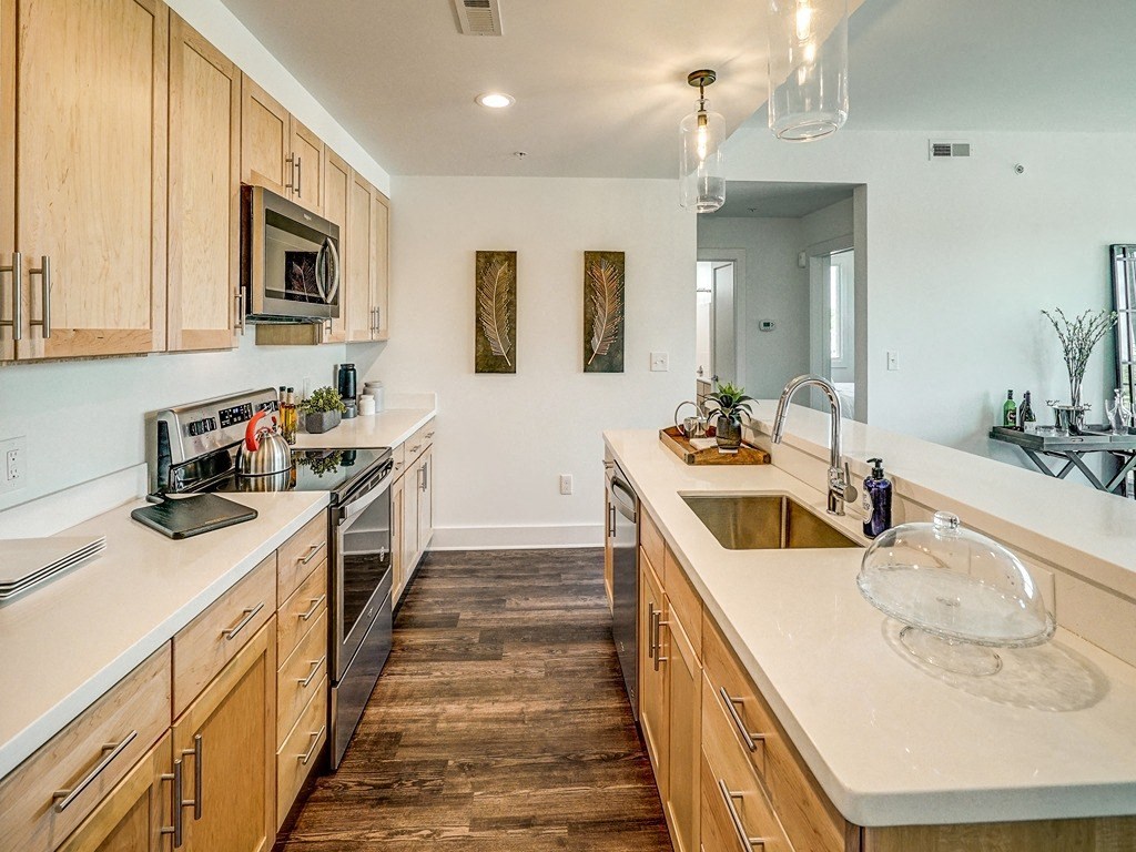a large kitchen with wooden cabinets and a sink