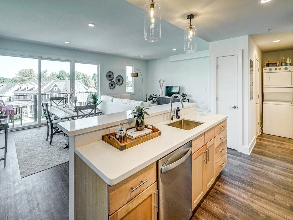 a kitchen with an island and a living room with a patio