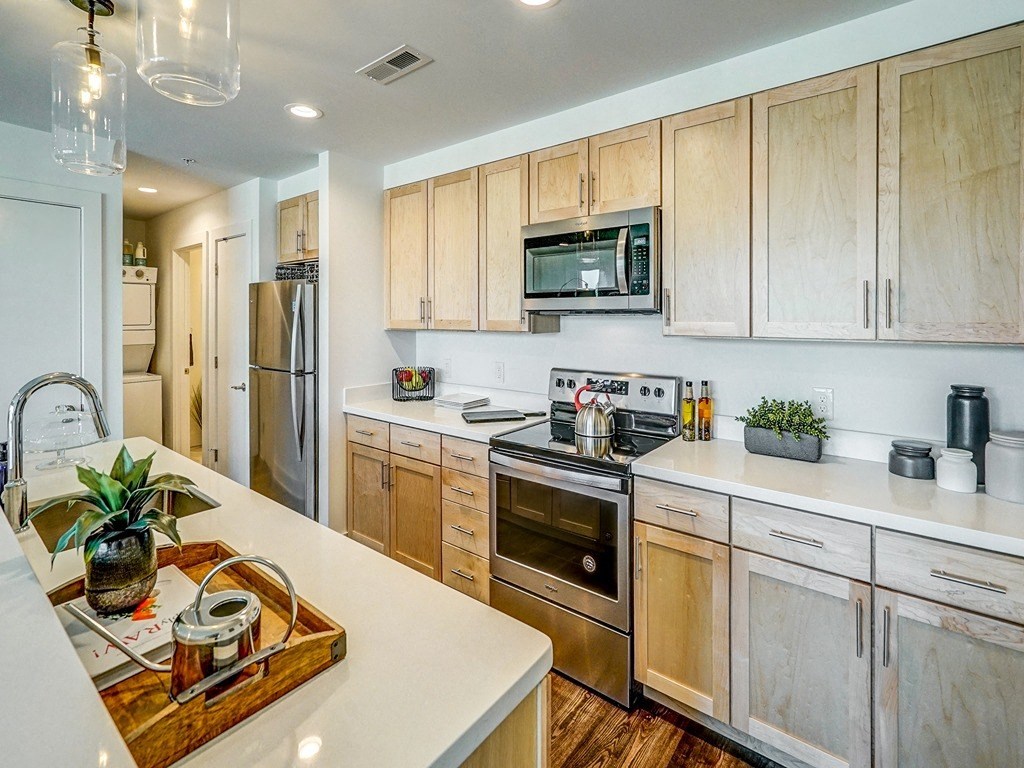 a kitchen with wooden cabinets and stainless steel appliances
