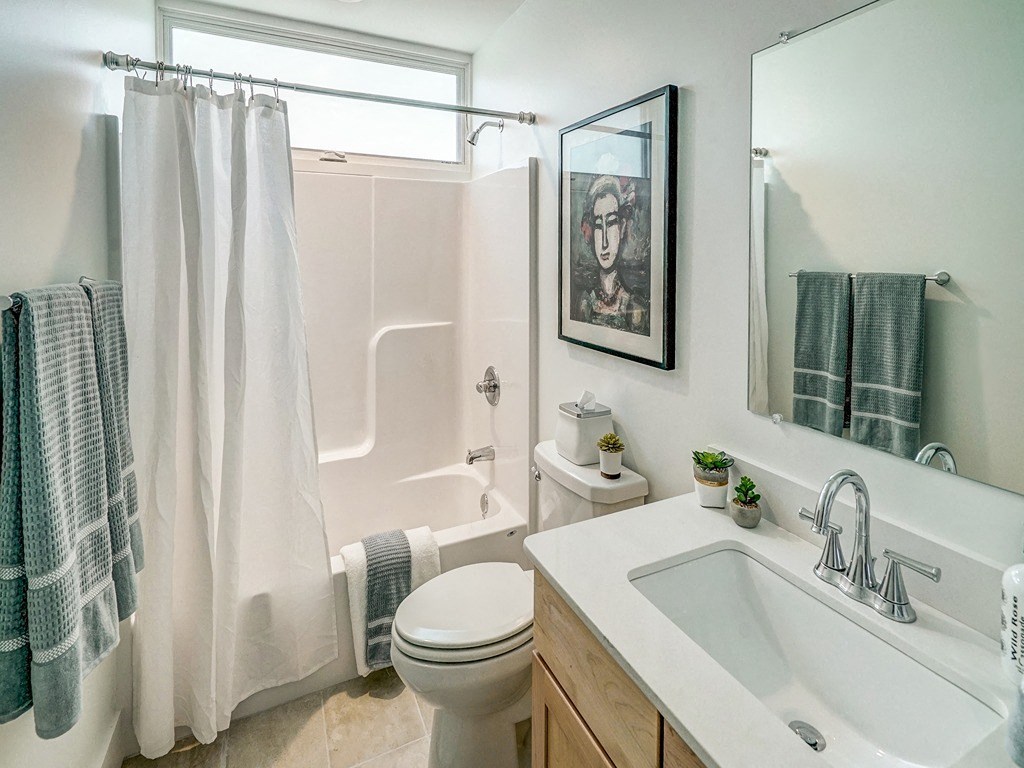 a bathroom with a shower and a sink and a toilet