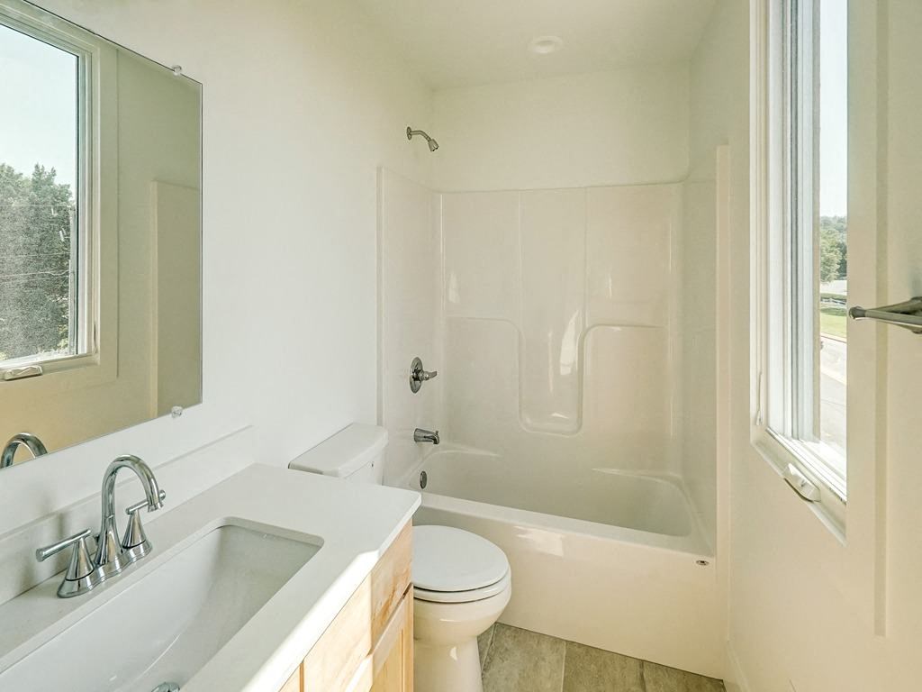 a bathroom with a sink toilet and a tub