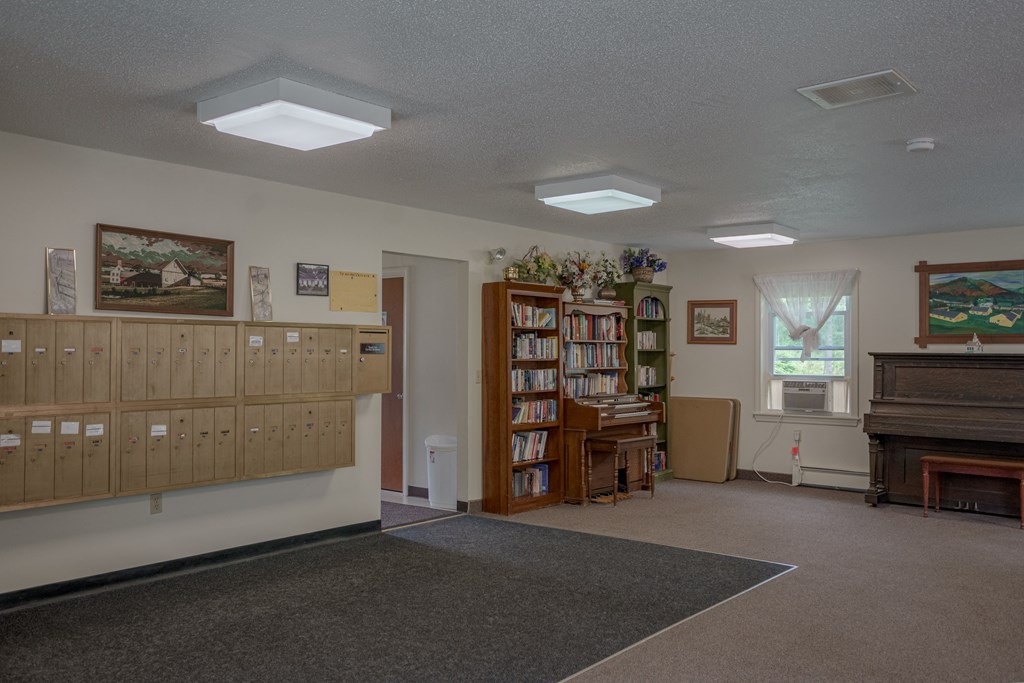 a room with a bookshelf and a piano