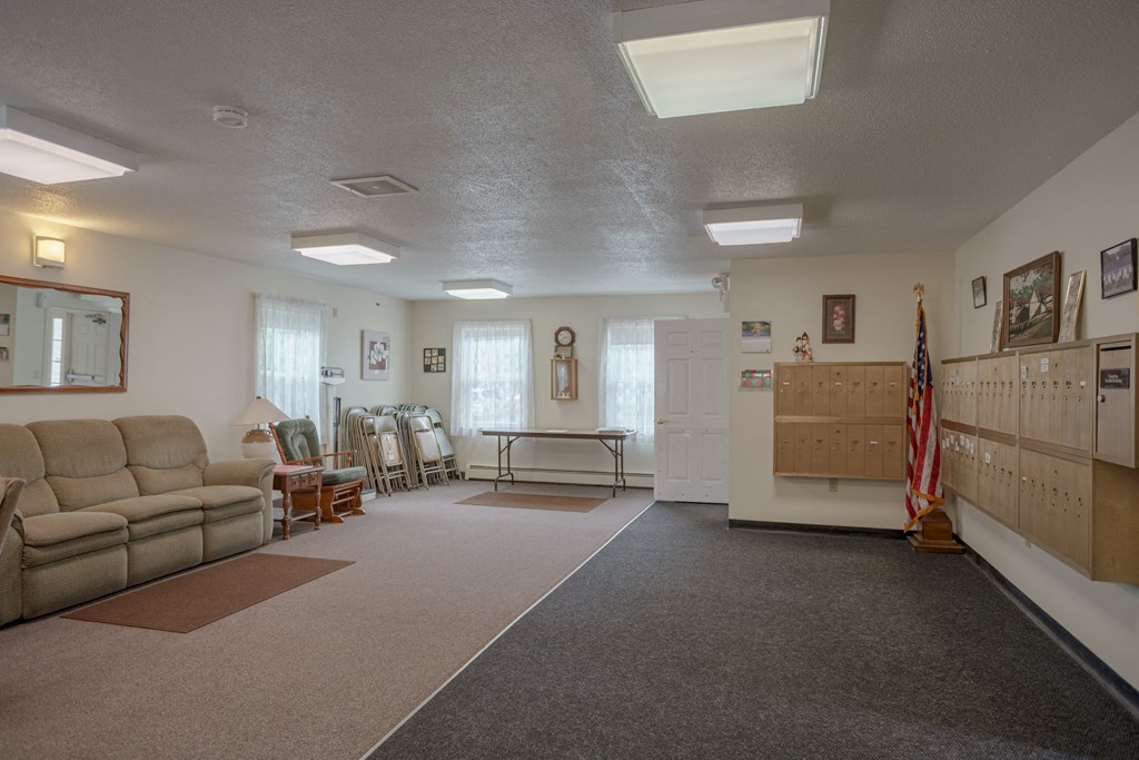 a living room with couches and chairs and a table and an flag
