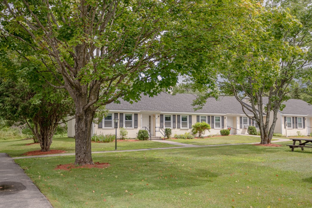 a large white house with trees in front of it