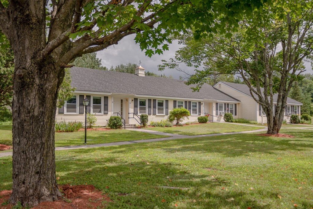 a white house with trees in front of it