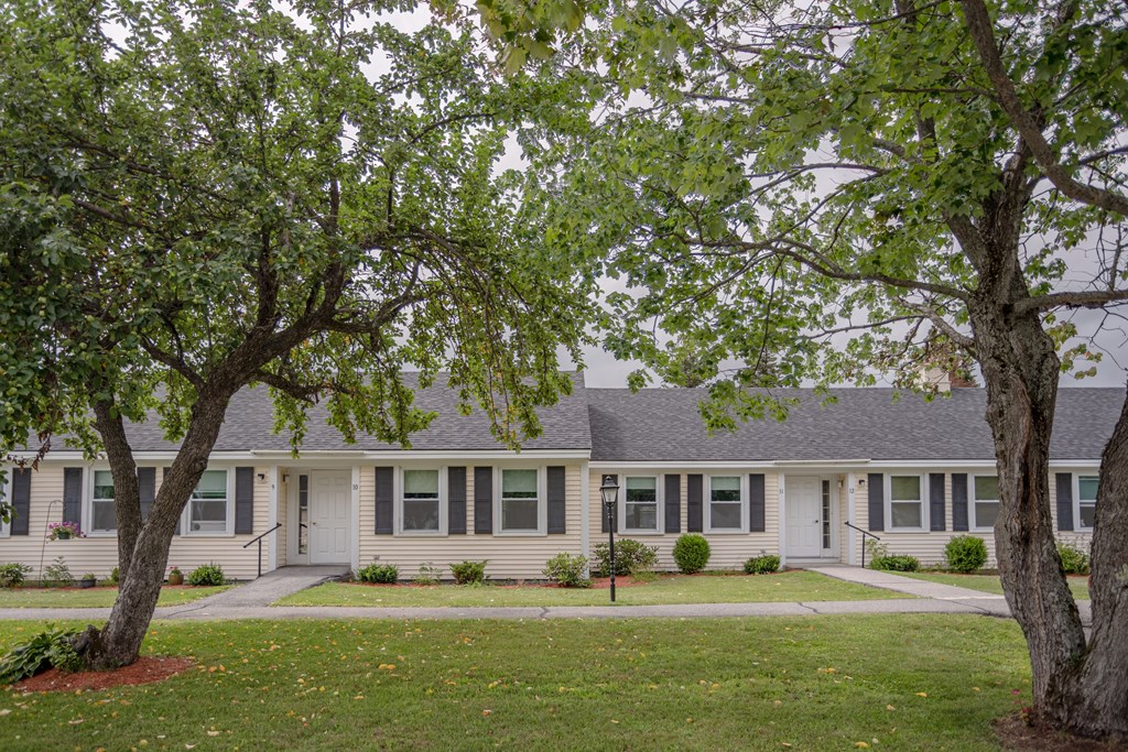 a white house with trees in front of it