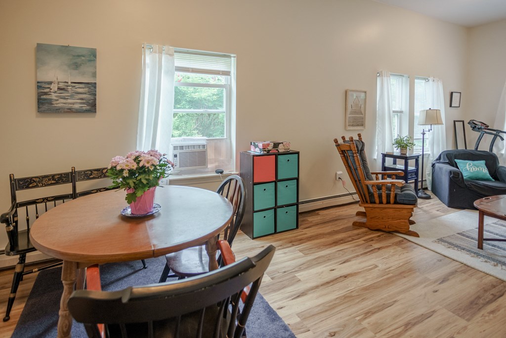 a dining room and living room with a table and chairs