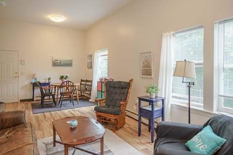 an open living room and dining room with a table and chairs and a large window