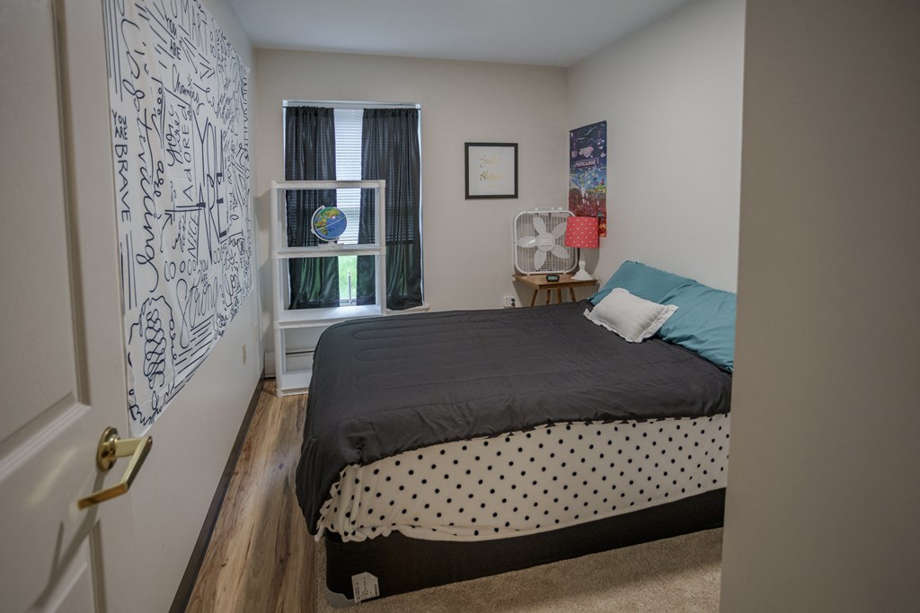 a bedroom with a bed and a window