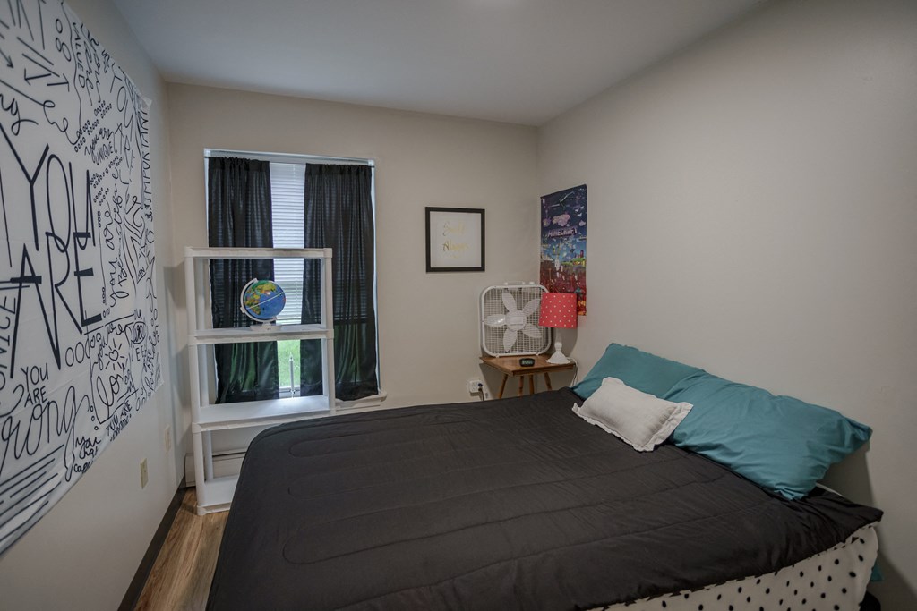 a bedroom with a bed and a window