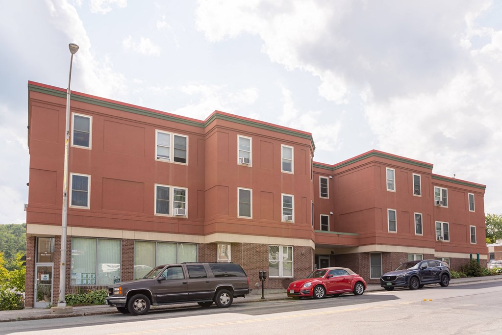 a large building with cars parked in front of it