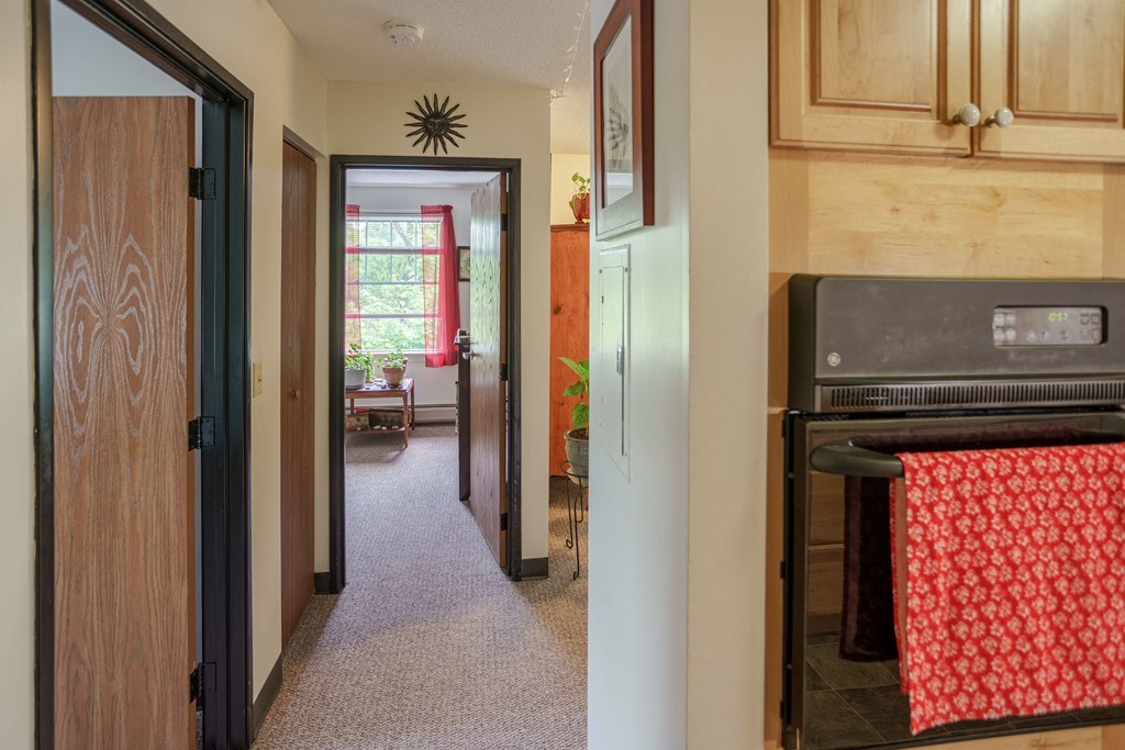 the view from the kitchen into the living room and the dining room