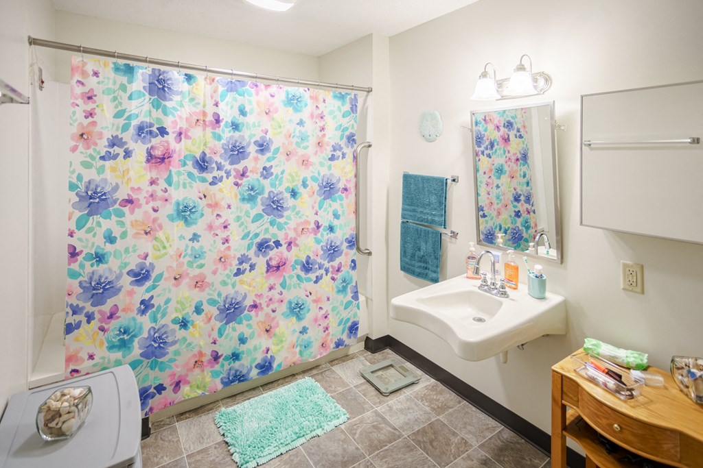 a bathroom with a shower curtain and a sink