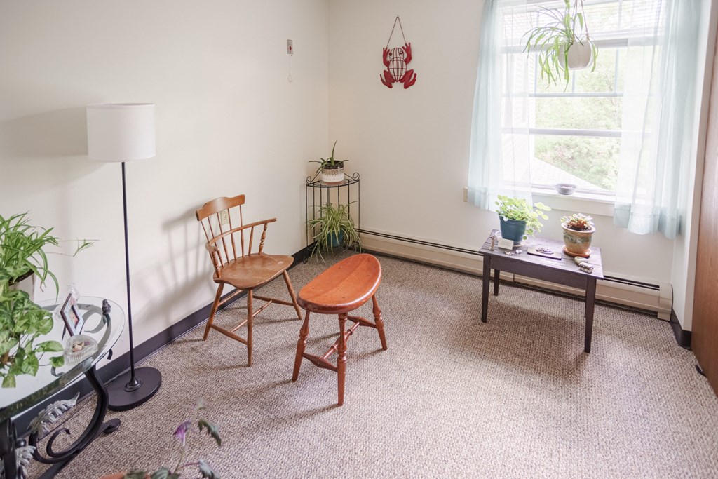 a living room with two chairs and a table