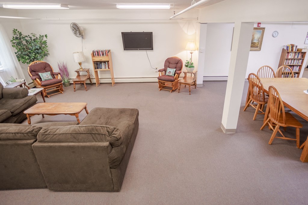 a living room with a couch and chairs and a table