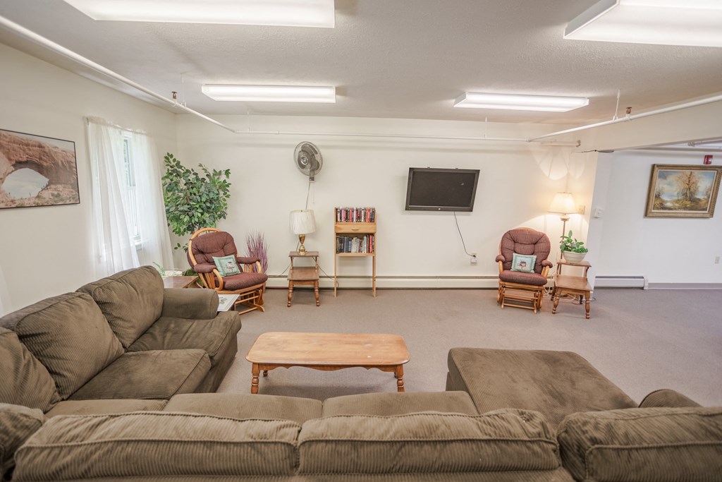 a living room with couches and chairs and a table