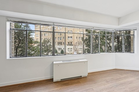 A room with a large window overlooking a cityscape.
