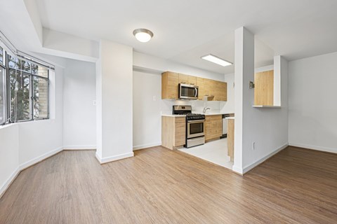 A kitchen with wooden floors and white walls.