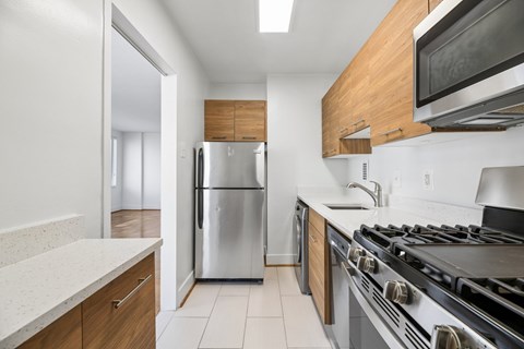 A modern kitchen with a stainless steel refrigerator and oven.
