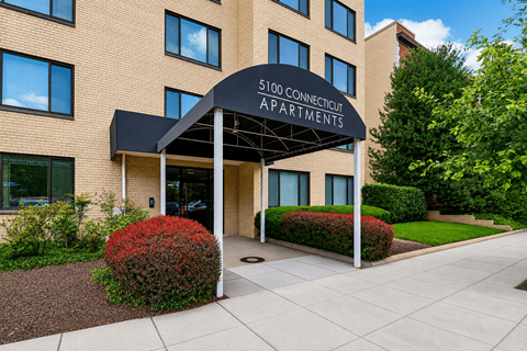The front of a building with the sign 5100 Connecticut Apartments.