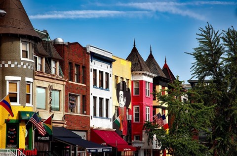 A row of colorful buildings with a clear blue sky above them.