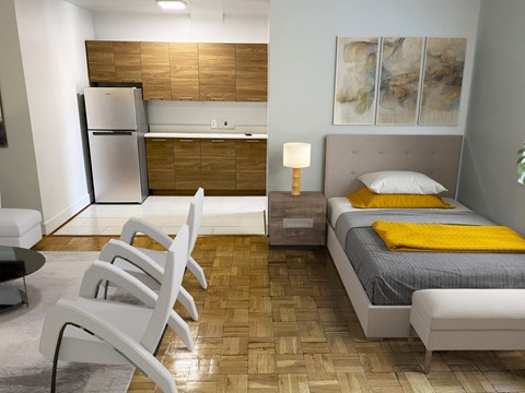 A modern bedroom with a bed, chair, and a refrigerator.