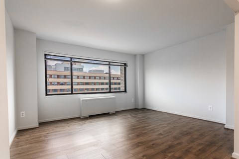 A room with a window overlooking a building.