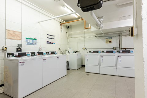 A laundry room with washers and dryers.