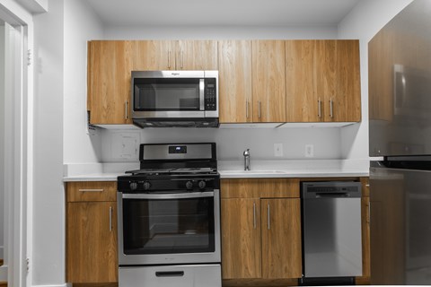 A kitchen with wooden cabinets and stainless steel appliances.