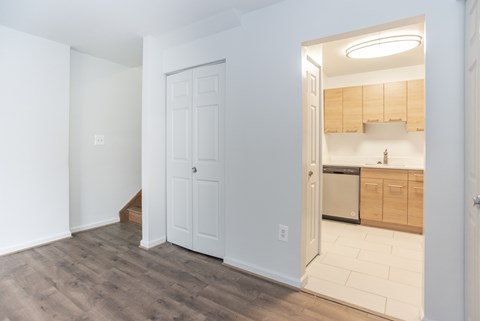 A kitchen with wooden cabinets and a white door.