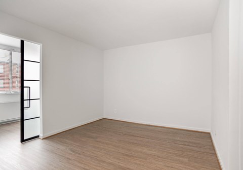 A room with a wooden floor and white walls.