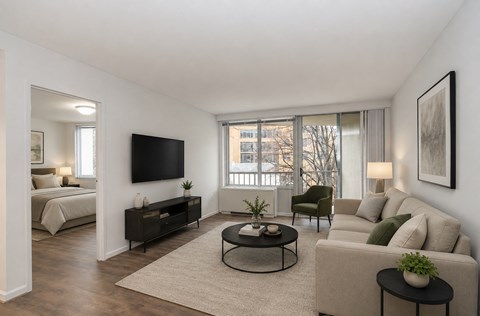 A living room with a flat screen TV mounted on the wall.