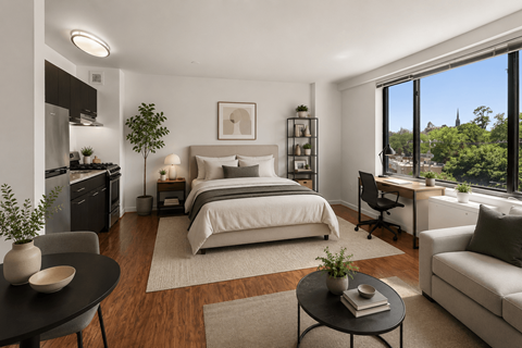 A modern bedroom with a large bed, a desk with a chair, and a potted plant.