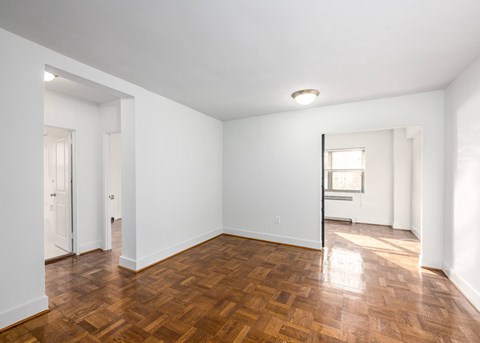 A room with wooden floors and white walls.