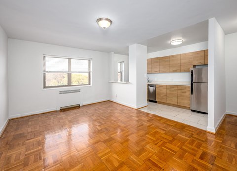 A kitchen with a wooden floor and white walls.