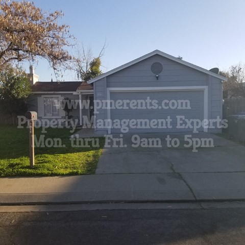 A garage with a sign that reads "www.preneurs.com Property Management Experts Mon. thru Fri. 9am to 5pm".