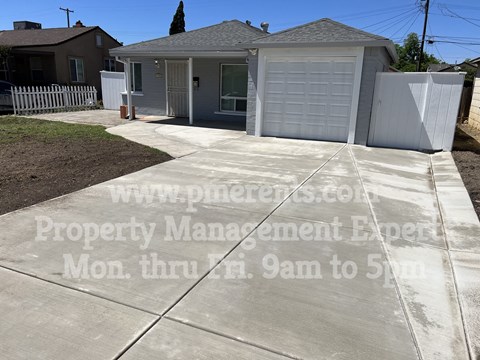 A residential property with a garage and a driveway is for sale.
