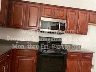 a kitchen with a stove top oven and a microwave
