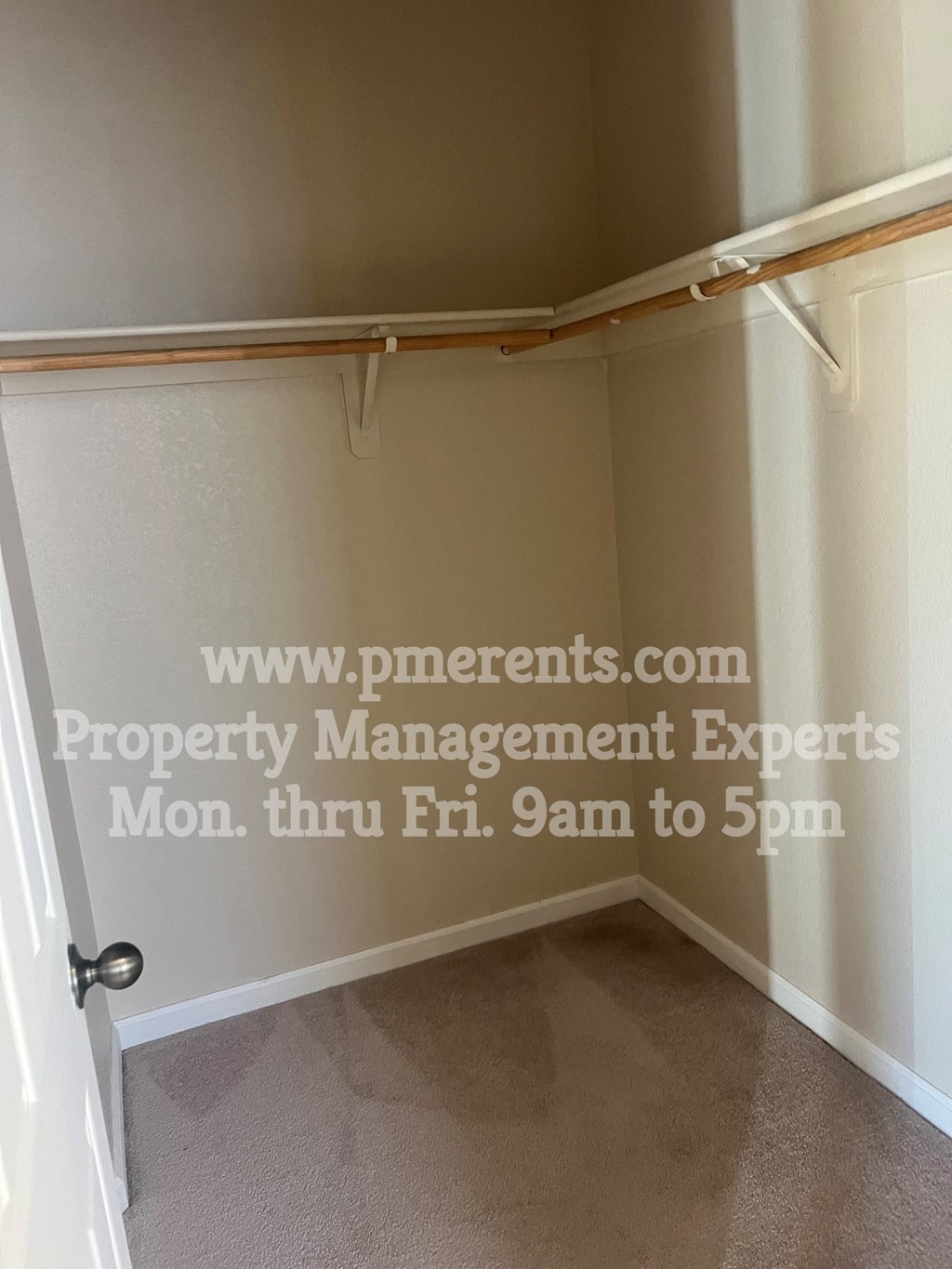 a walk in closet in a bathroom with a shower curtain