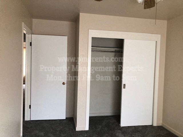 a bedroom with a closet and a mirrored door