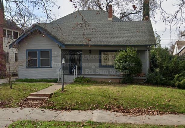 A house with a sign that says "DZJ Gooch's" on it.