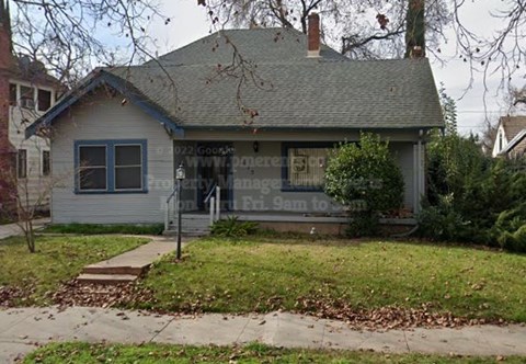 A house with a sign that says "DZJ Gooch's" on it.