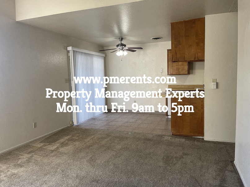 A room with a ceiling fan and a window with blinds, and a website address for property management experts.