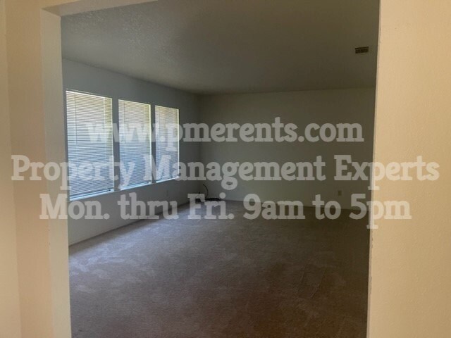 A room with a website address for property management experts displayed on the wall.
