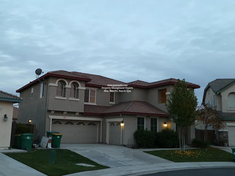 A house with a red roof and a garage is shown.