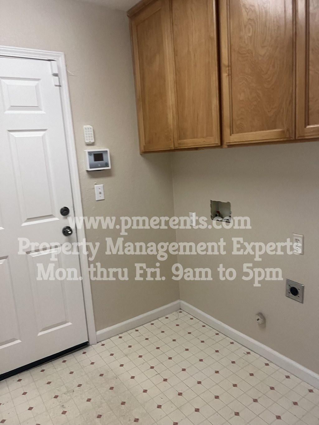 a door into a room with cabinets and a door to a closet