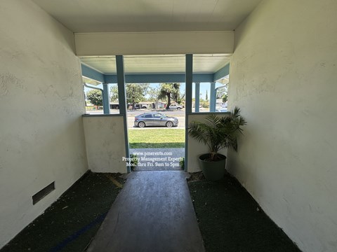 A sign in the window of a building advertises property management services.