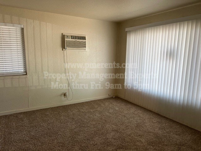 an empty room with a heater and a window