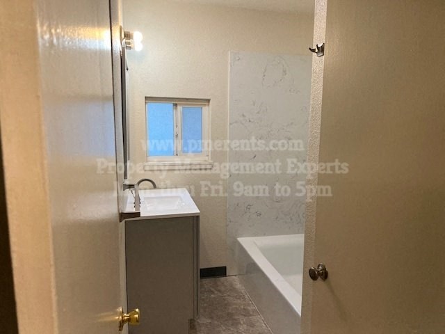 a bathroom with a sink and a bath tub